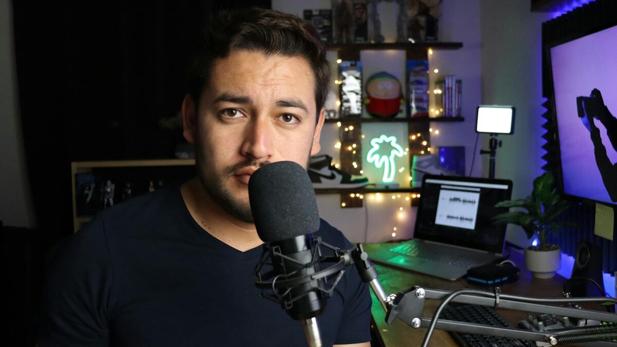 Content creator filming with microphone and neon-lit studio setup