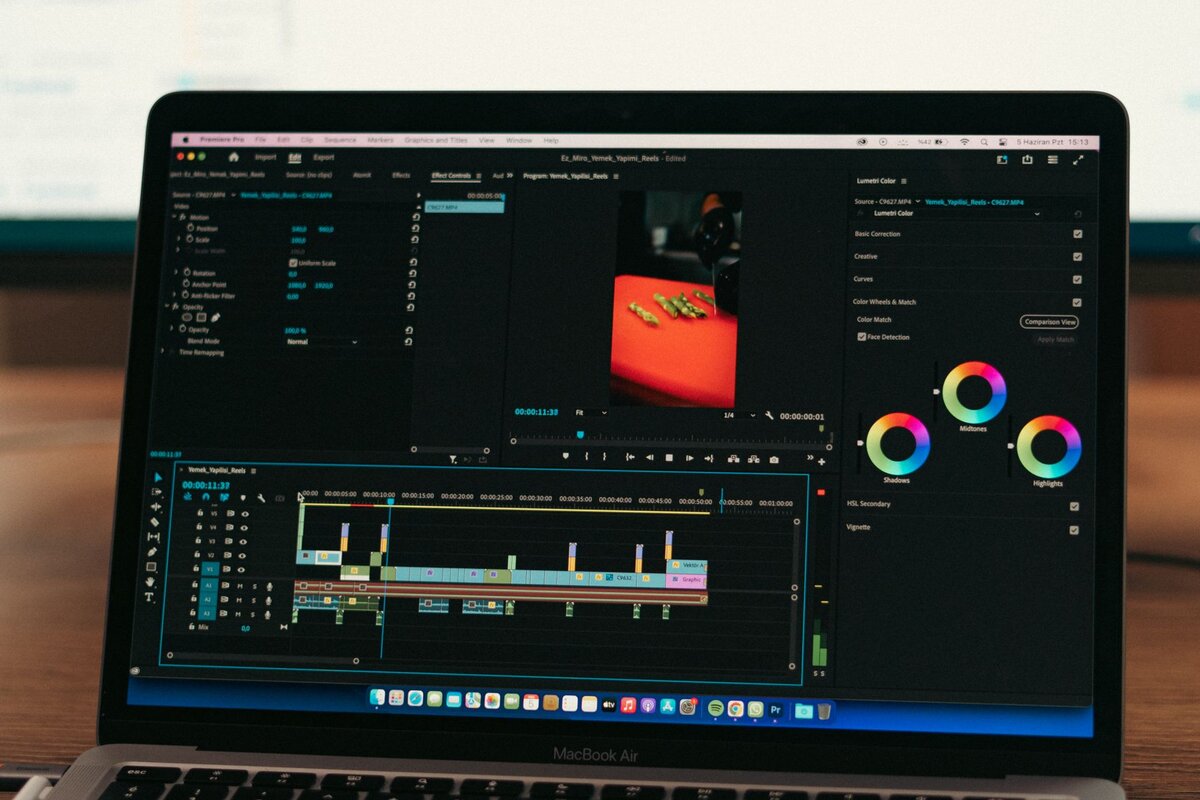 Faceless YouTube creator workspace with microphone and editing screen